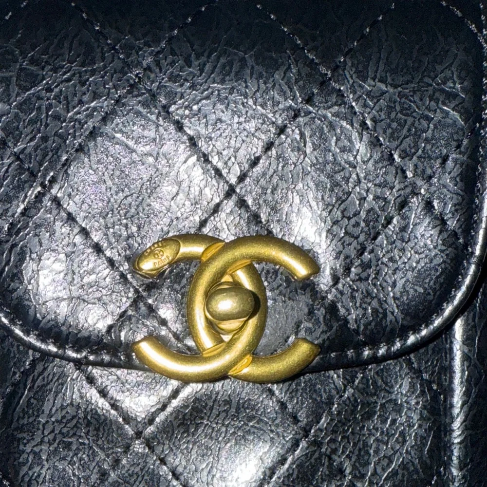 CHANEL Black Quilted Mini Bag with Gold Accents